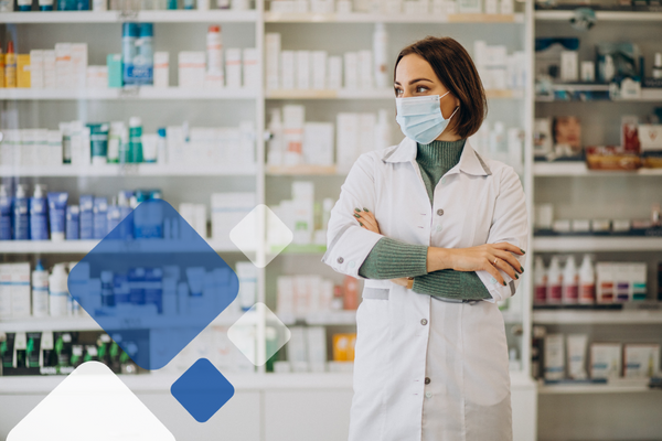 Pharmacist waiting at the counter of the pharmacy